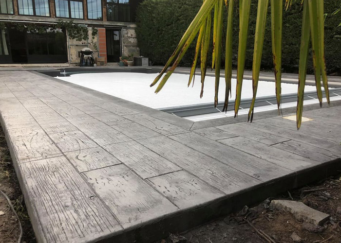 Terrasse extérieur à Salles- béton imprimé coloré dans la masse - teinte gris Otarie - finition lames de bois vieilli 